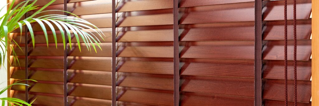 Close-up of warm wood blinds with slats tilted open