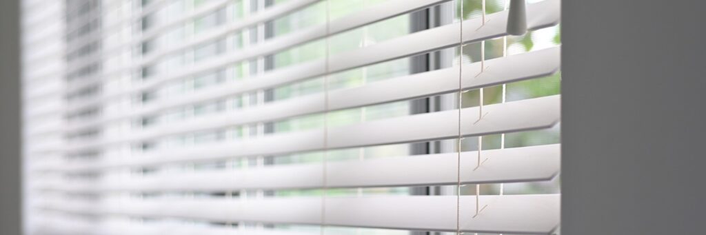Close-up of white horizontal blinds